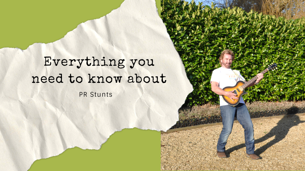 TV star Noel Edmonds holding a guitar and pretending to play in aid of a PR stunt by Palamedes for Samaritans